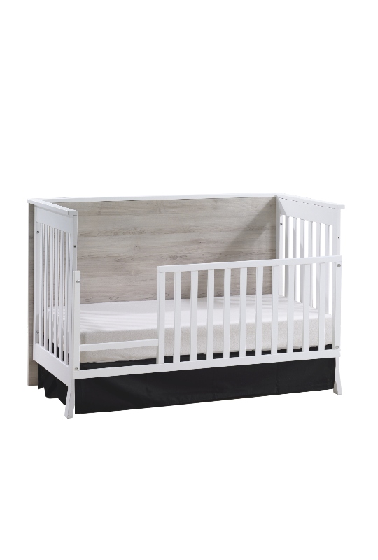 Metro crib in white used as toddler bed with gate